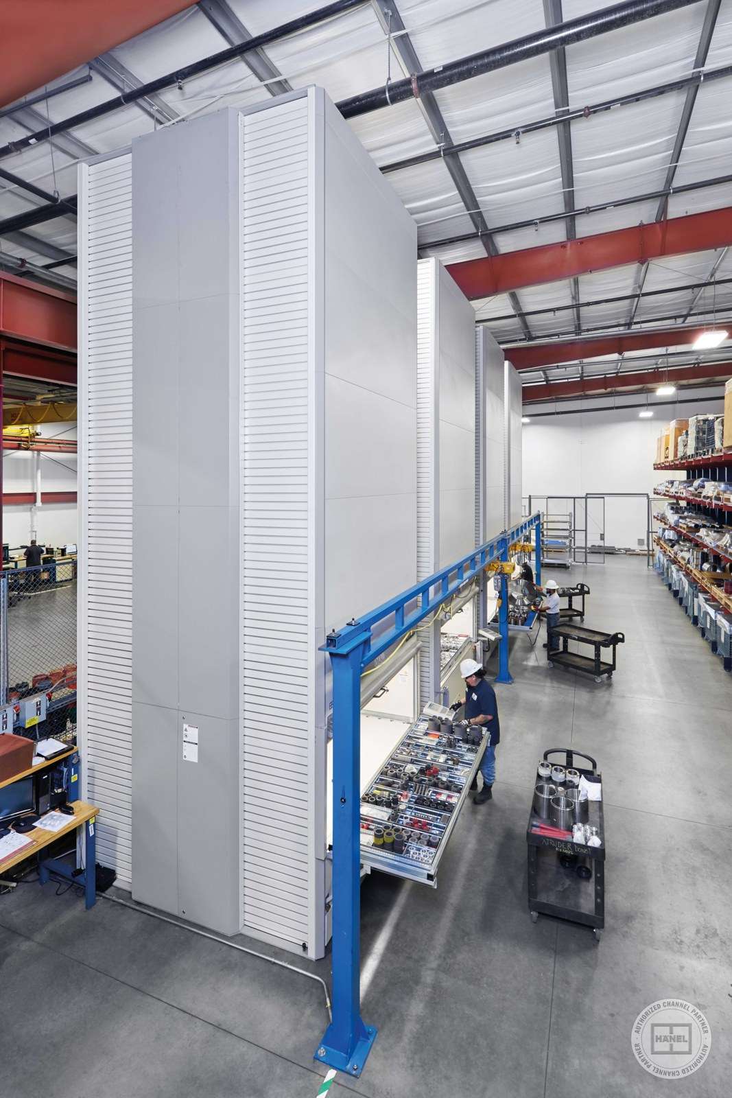 Tall Hänel Lean-Lift units using vertical space inside a warehouse